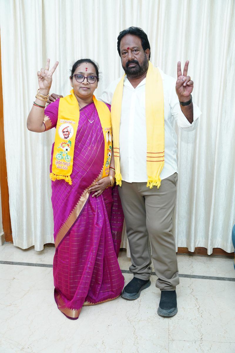 Baskarla Subhadra with a supporter, both showing the victory sign
